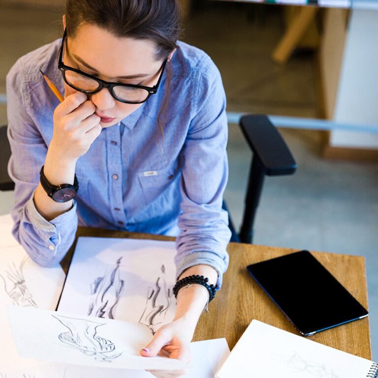 pensive-woman-fashion-designer-sitting-and-PHGZYEM